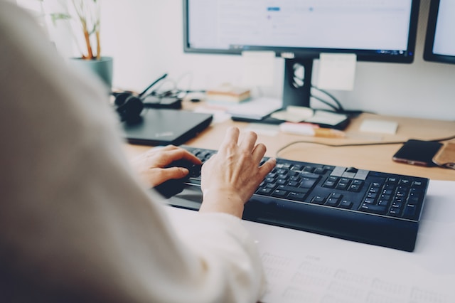 Receptionist typing message on computer